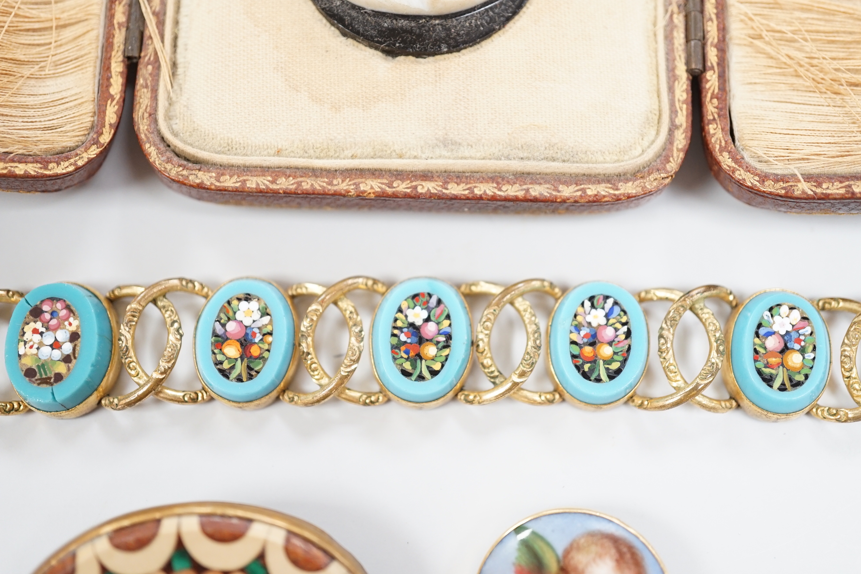 A Tassie style cased cameo, a micro-mosaic bracelet, a pietra dura brooch and a porcelain brooch.